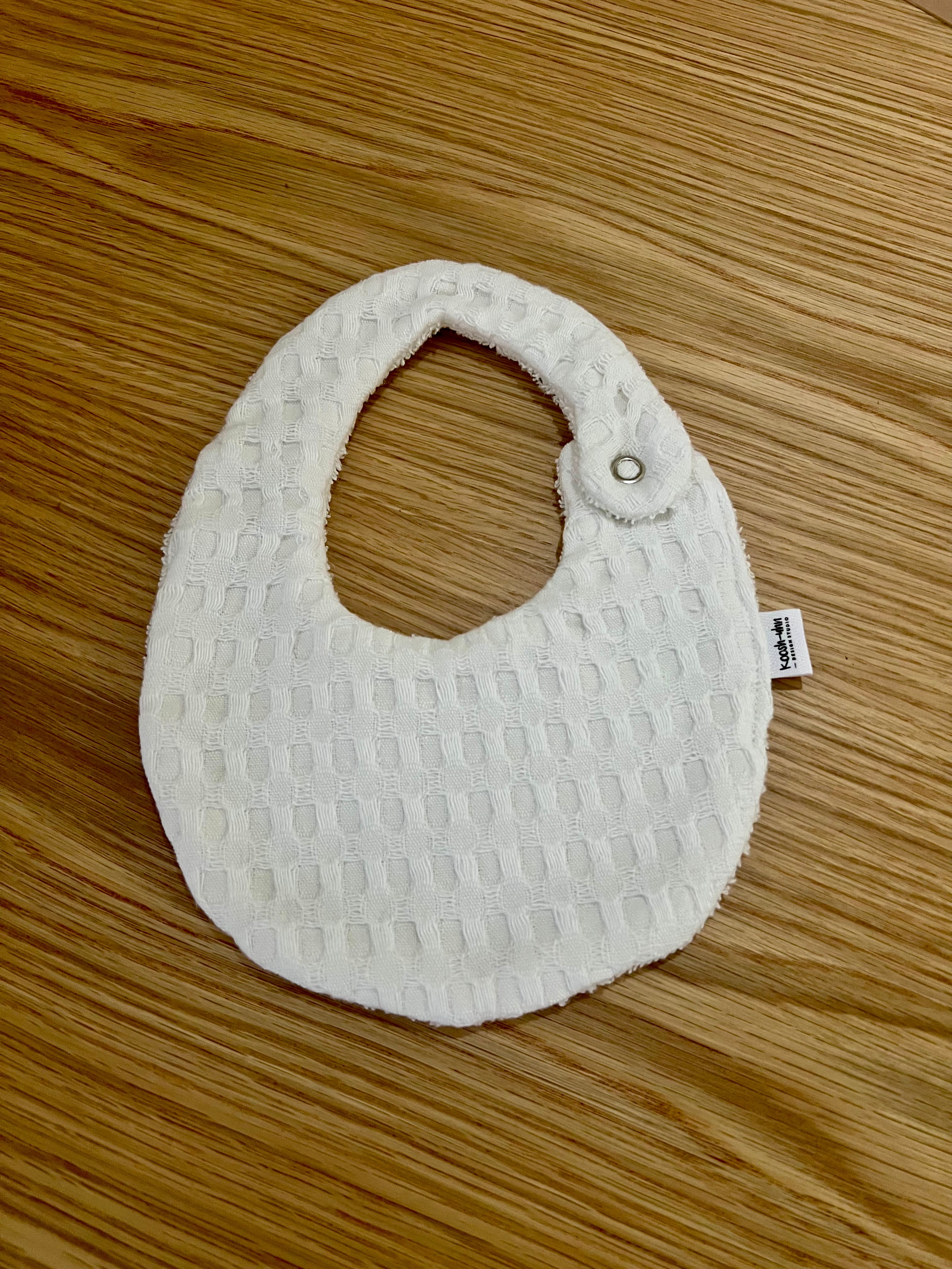 Koosh-uhn Bibs