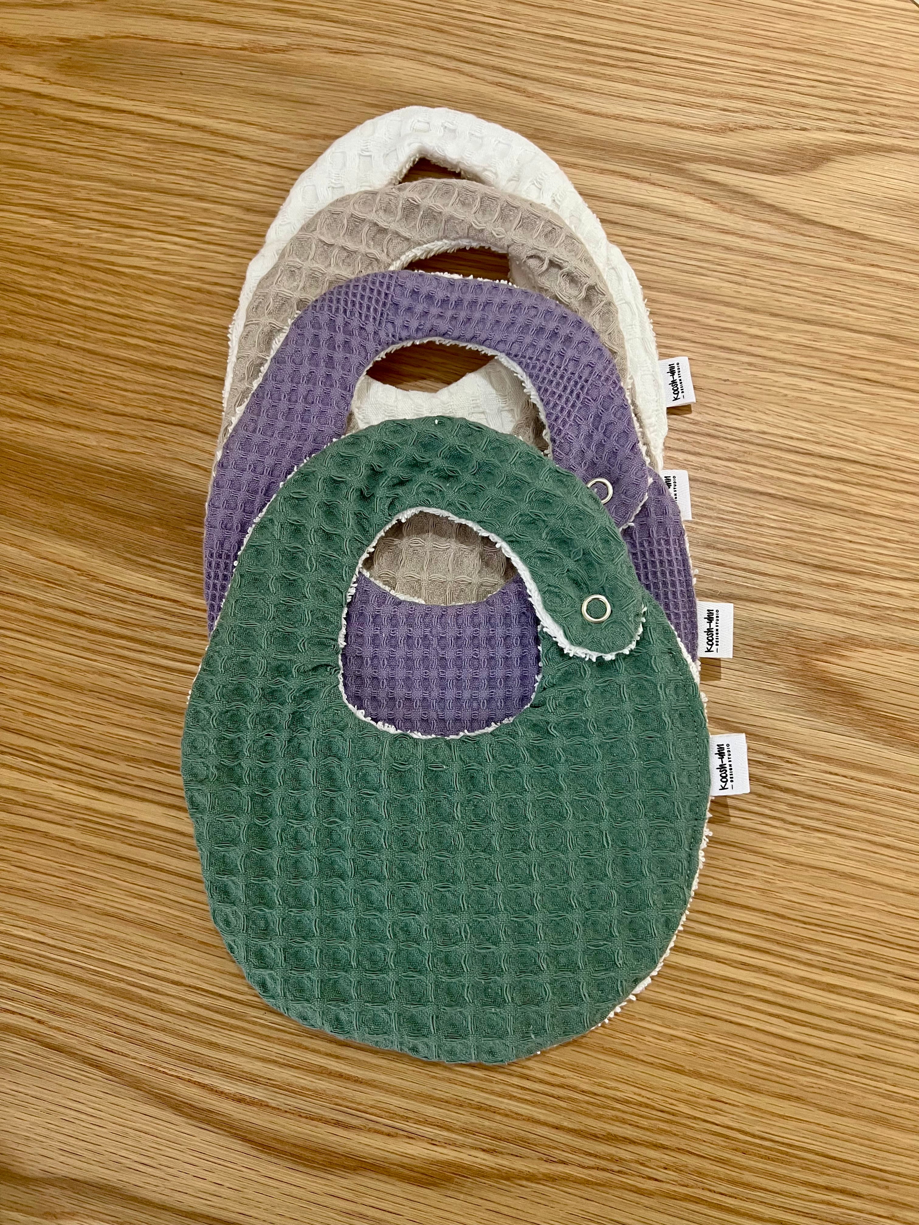 Koosh-uhn Bibs