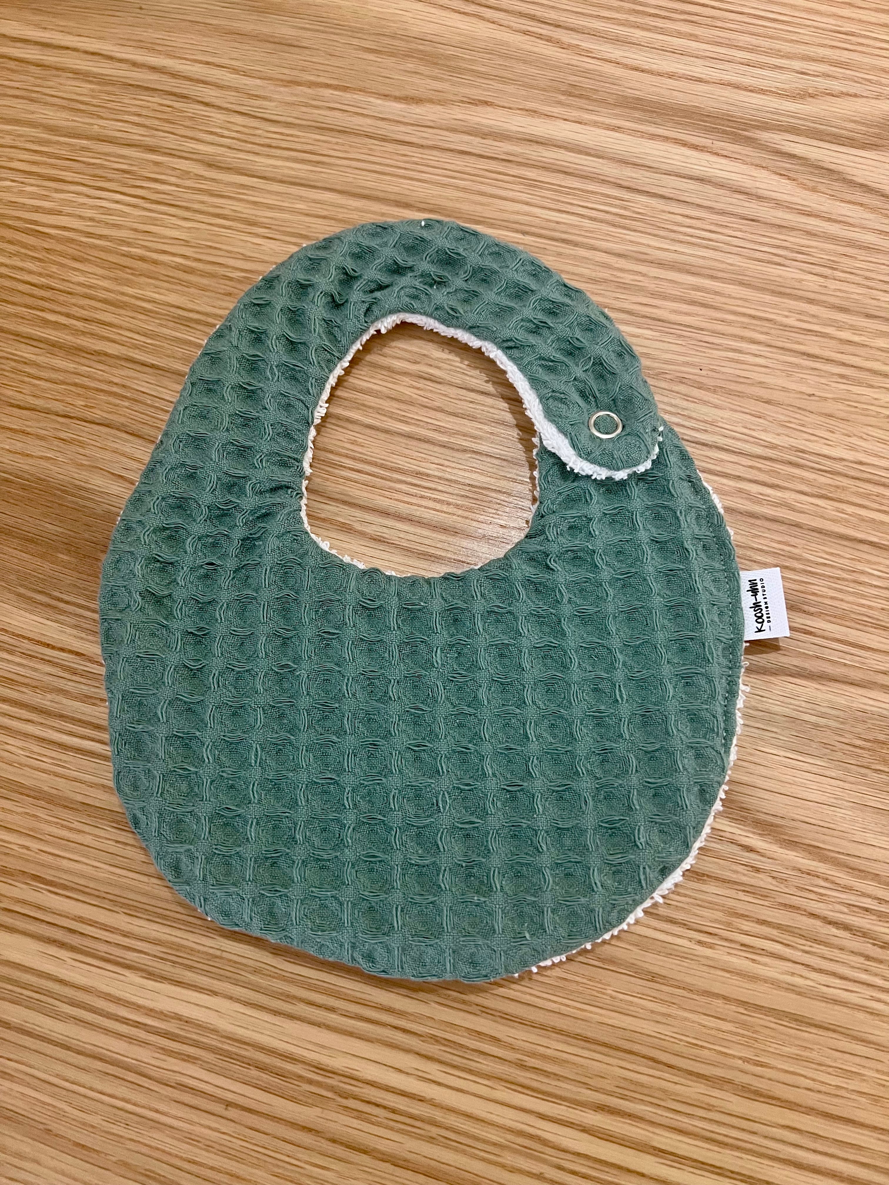 Koosh-uhn Bibs