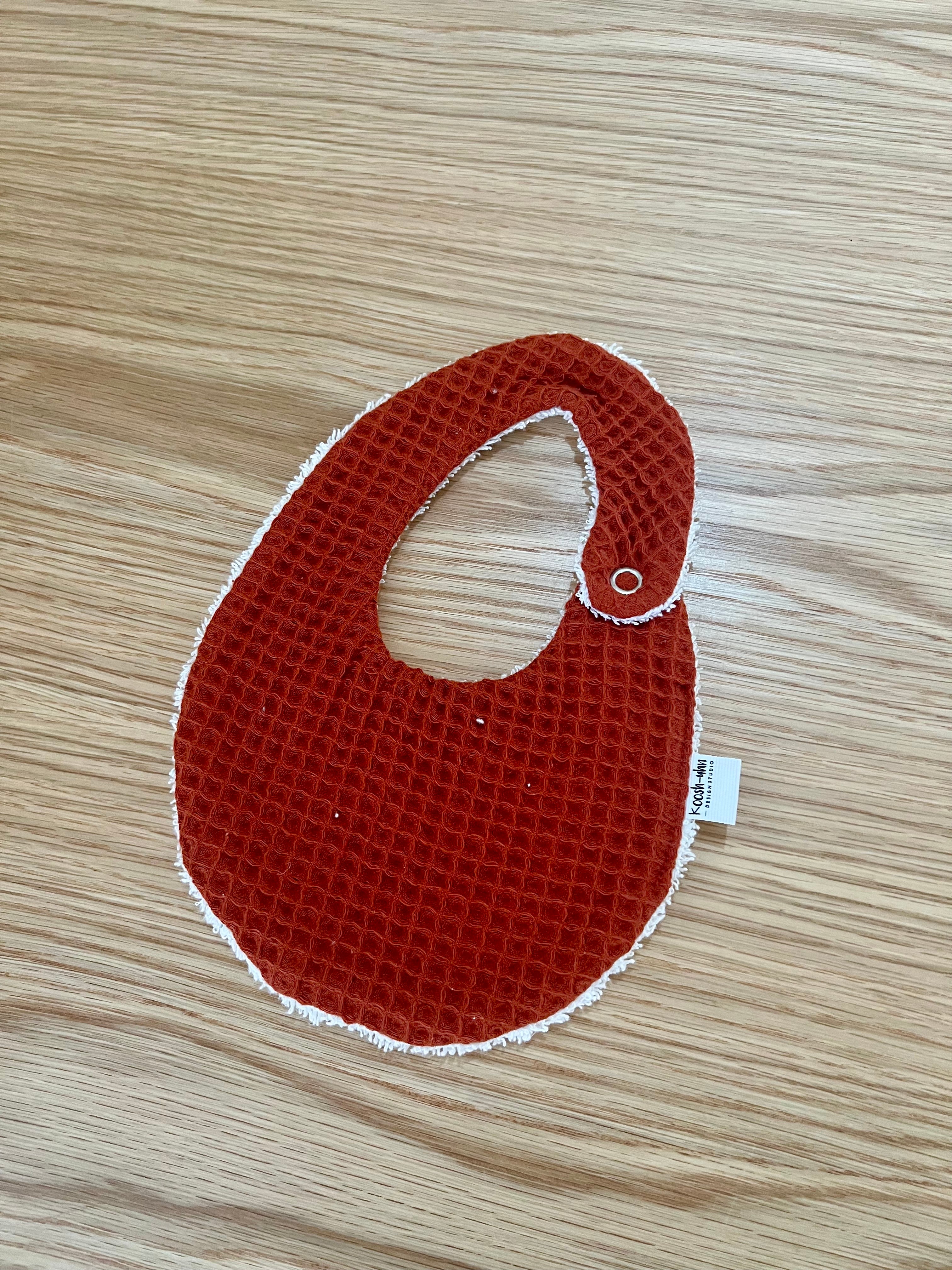 Koosh-uhn Bibs